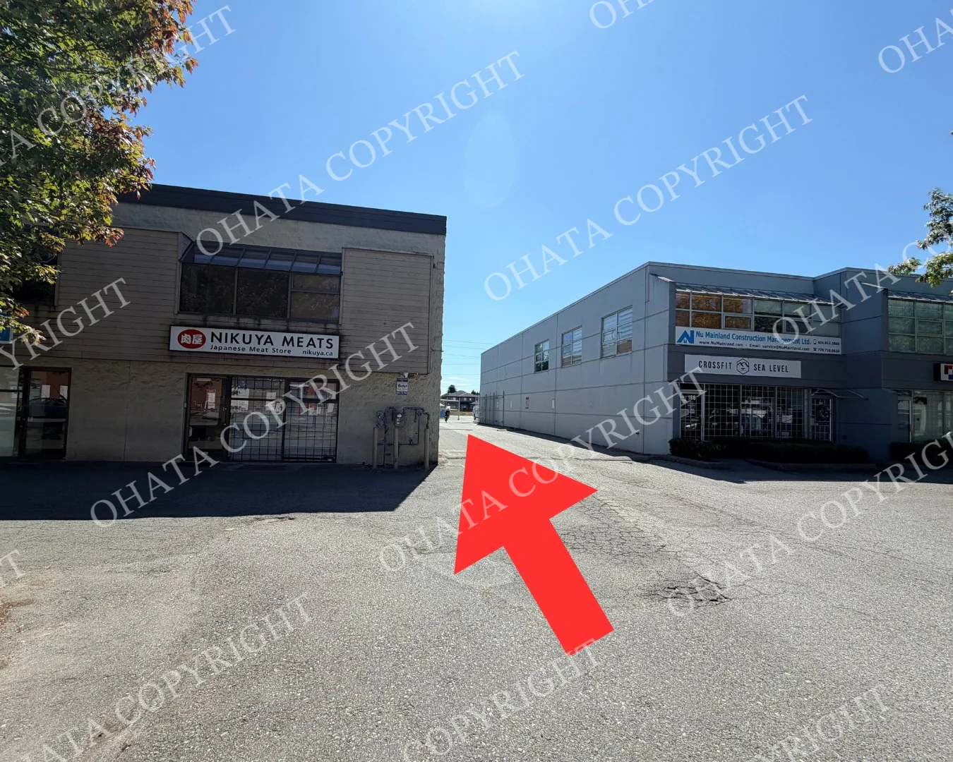 Driving route around the building toward the rear warehouse entrance of Ohata Resource Canada Inc.
