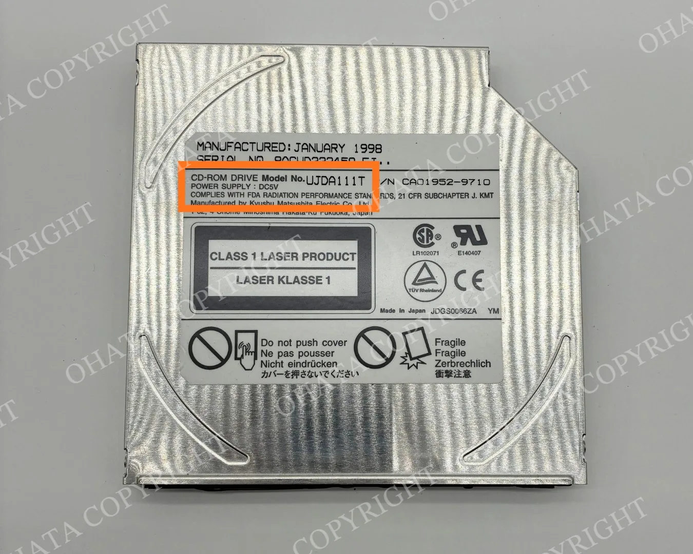 Older slim CD-ROM drive with manufacturer identification label
