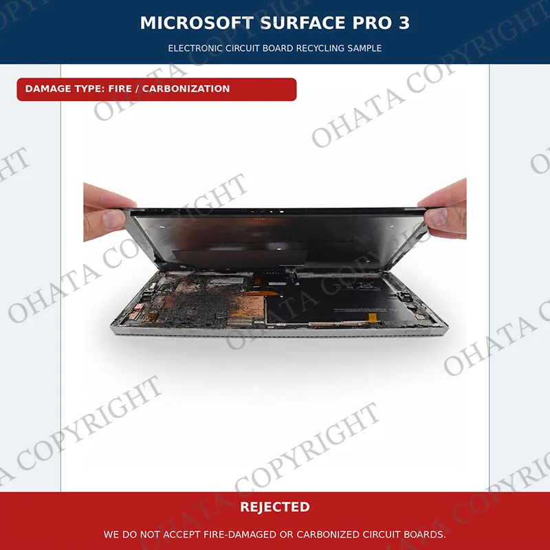 Open Microsoft Surface Pro 3 with severe fire damage and carbonization around its internal components.