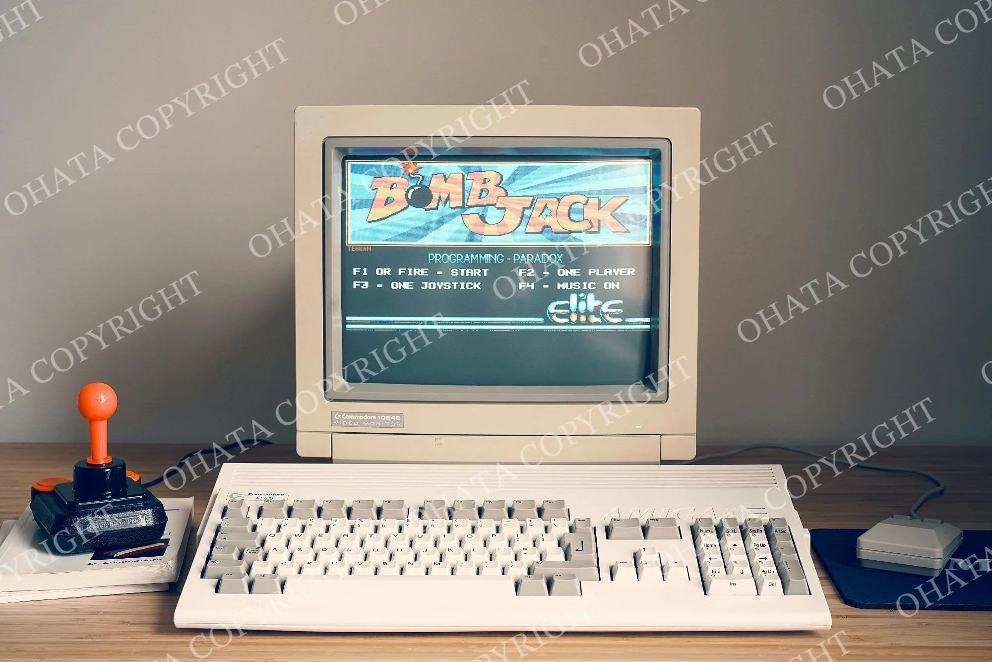 Beige CRT computer monitor displaying a game, connected to a separate desktop computer.