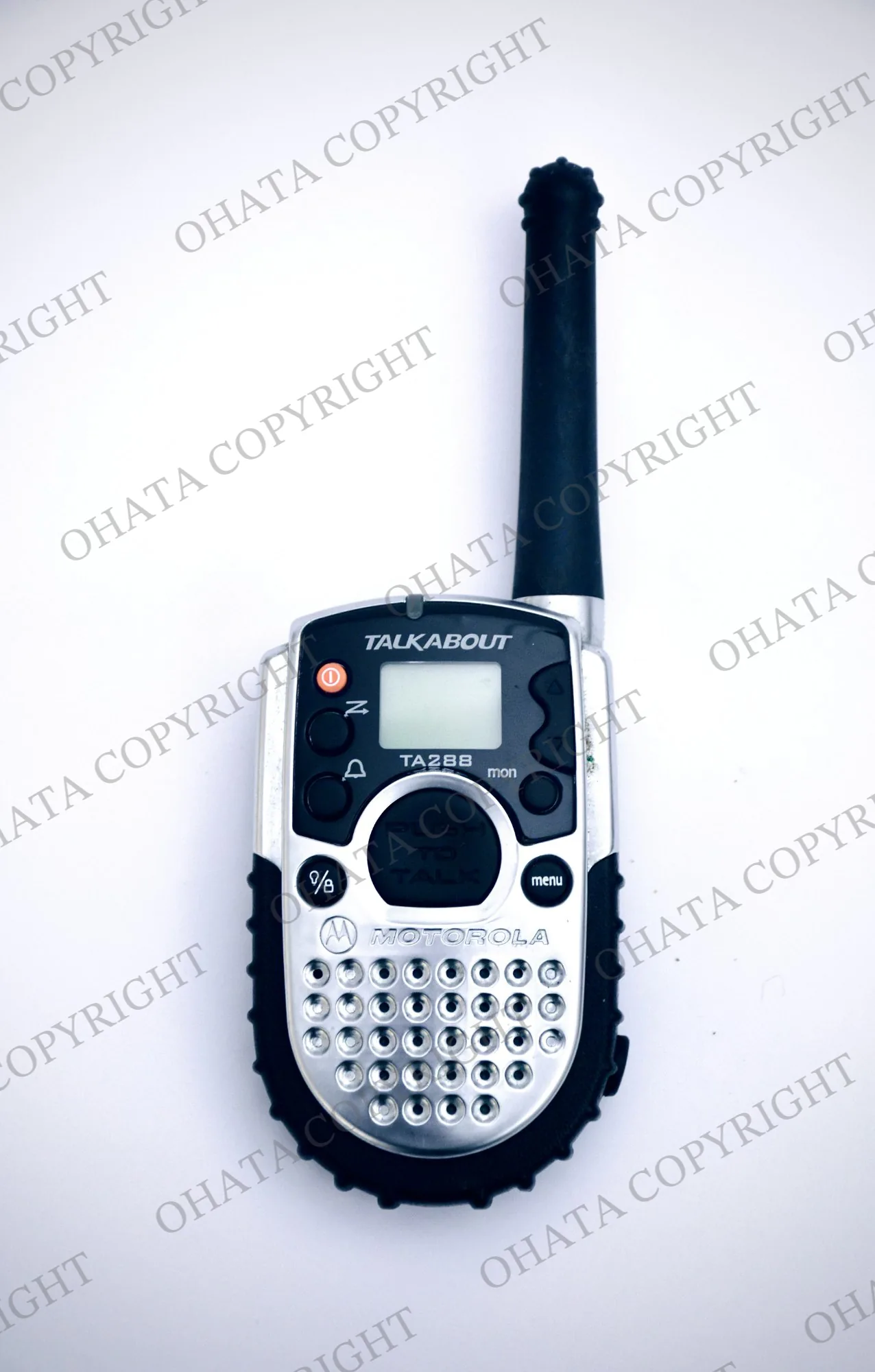Silver and black Motorola Talkabout walkie-talkie with an antenna, display, and push-to-talk button.