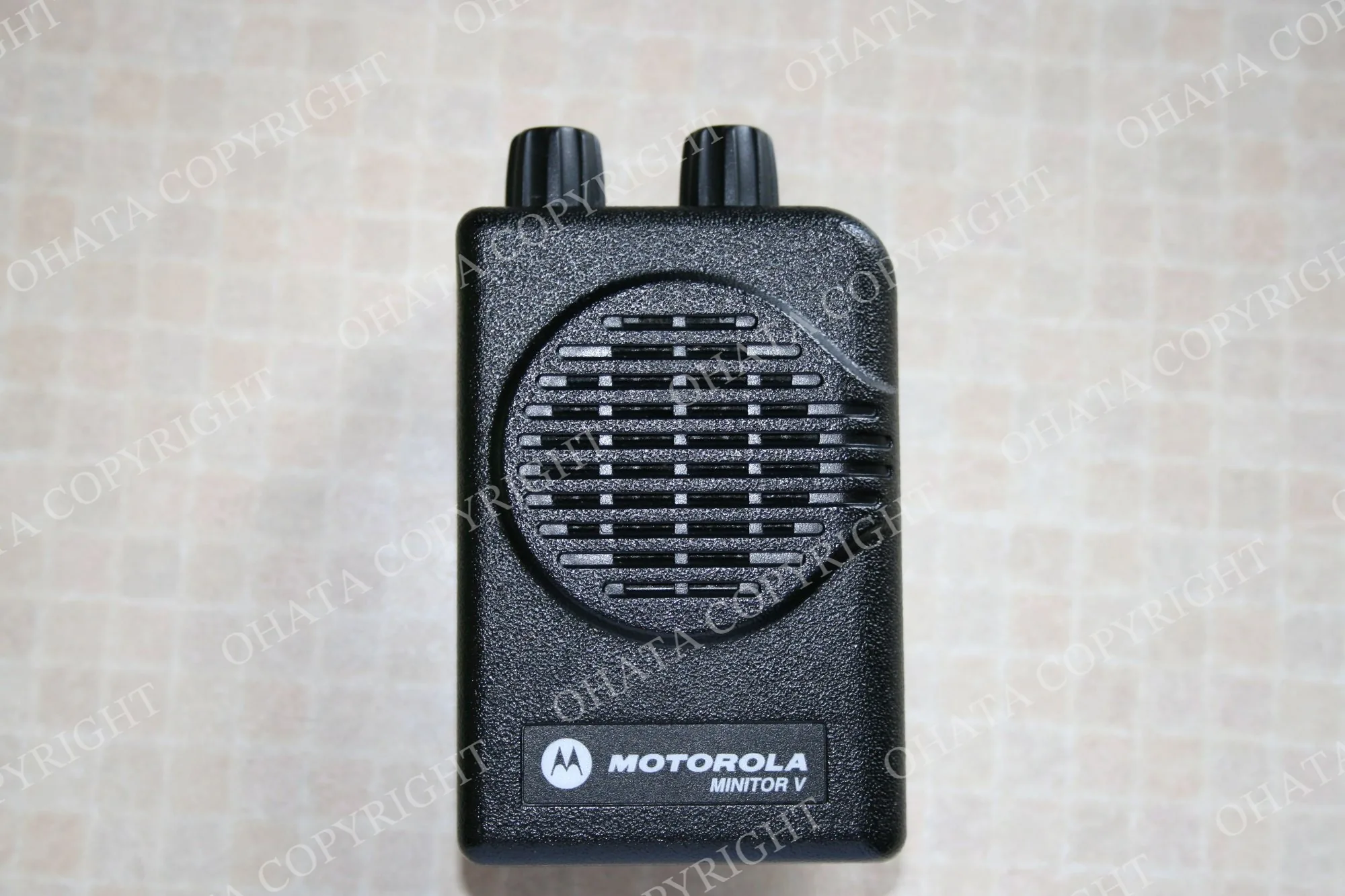 Numeric pager with a small display and control buttons.