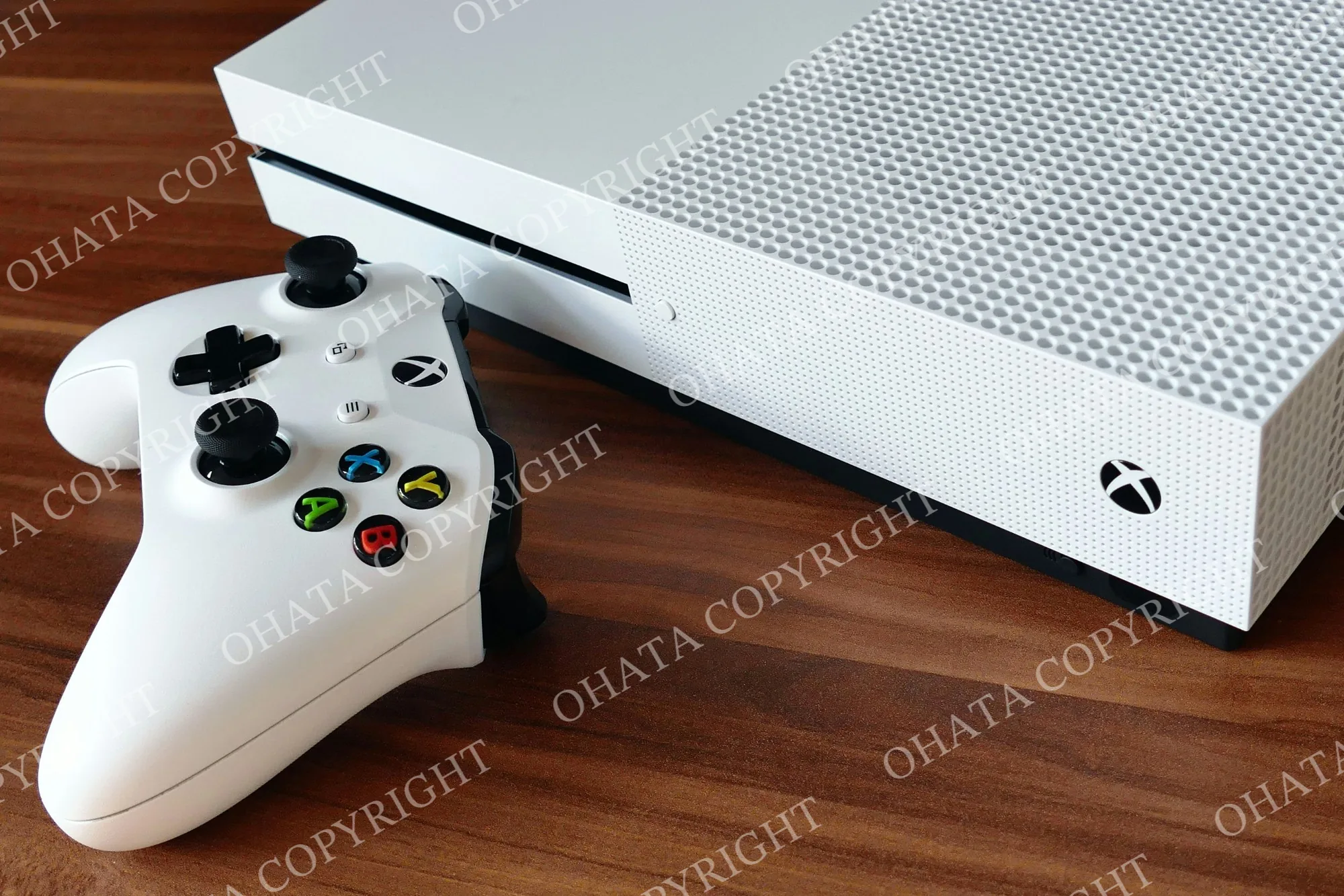 White Xbox video game console with a matching wireless controller