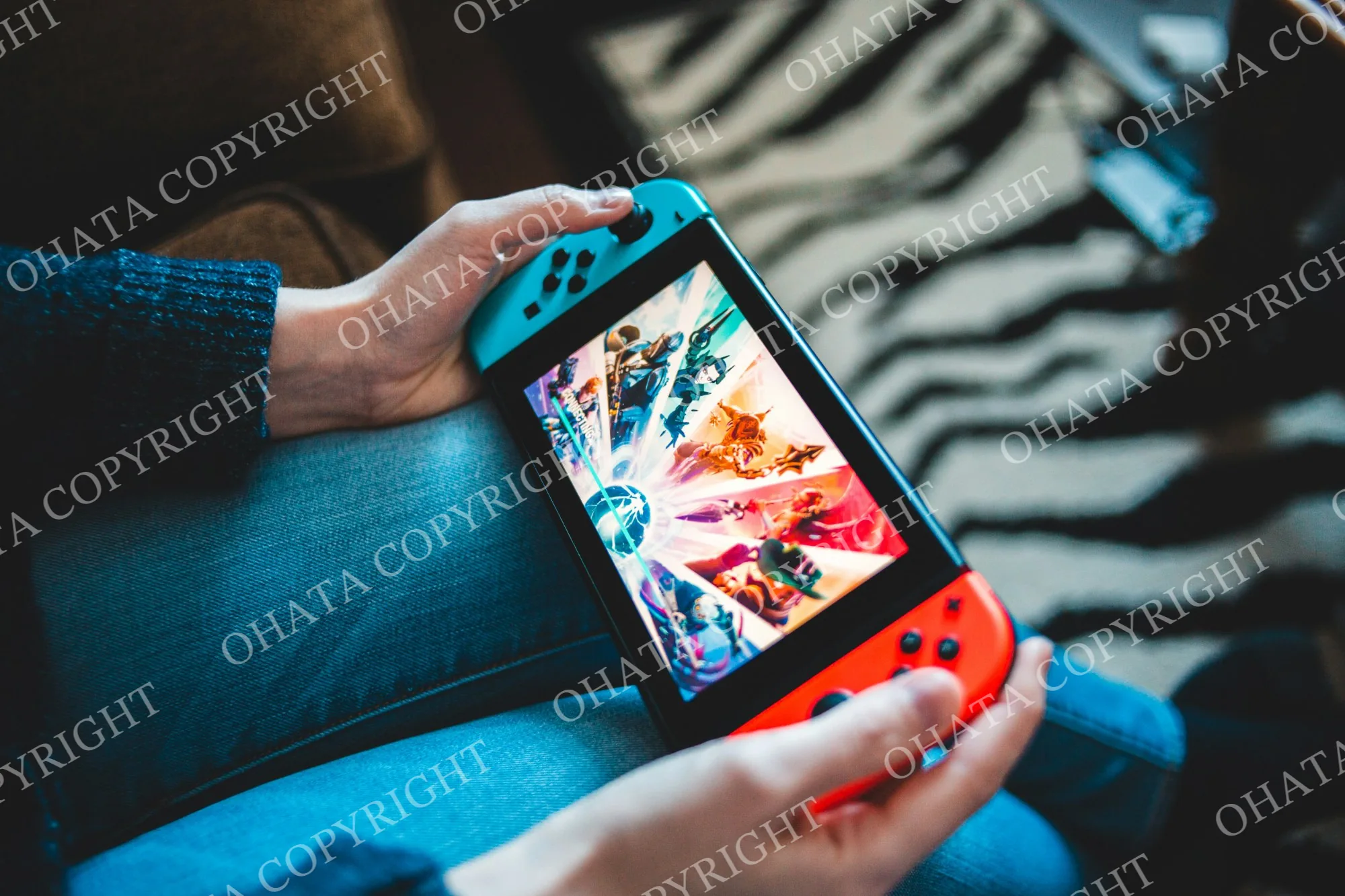 Handheld Nintendo Switch console with blue and red controllers
