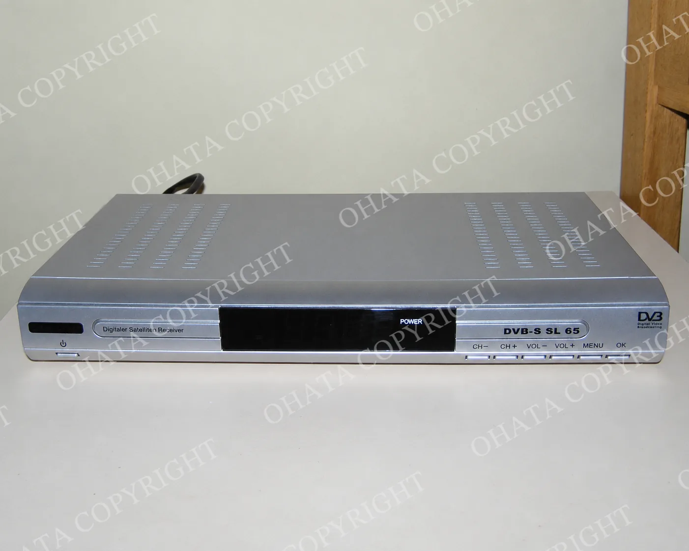 Silver Silvercrest SL65 satellite TV receiver with a front display and channel controls.
