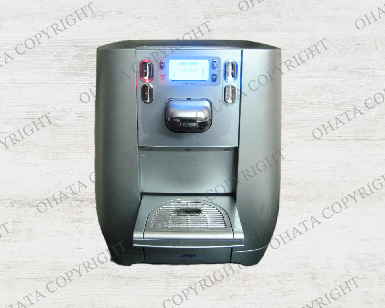 Silver countertop water dispenser with a digital display, dispensing controls and a drip tray.