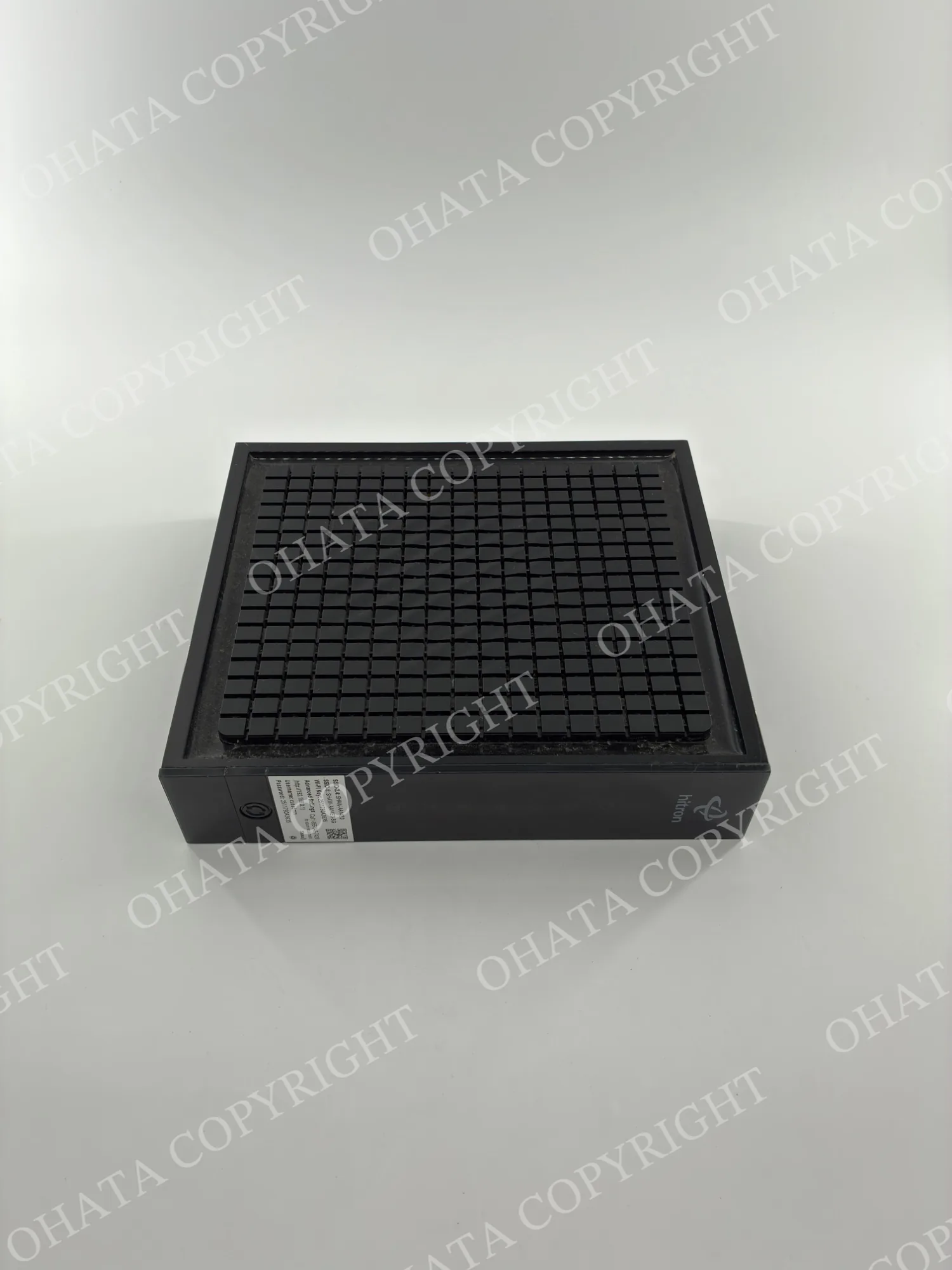 Angled front view of a Hitron desktop modem and Wi-Fi router showing the top ventilation grille and compact desktop design.