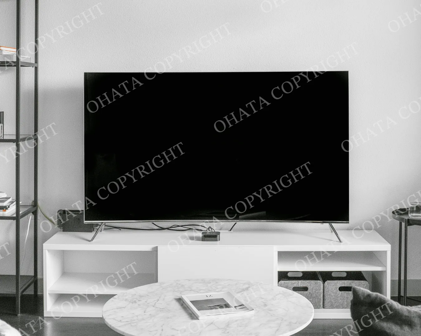 Flat-screen television on a white media cabinet in a living room.