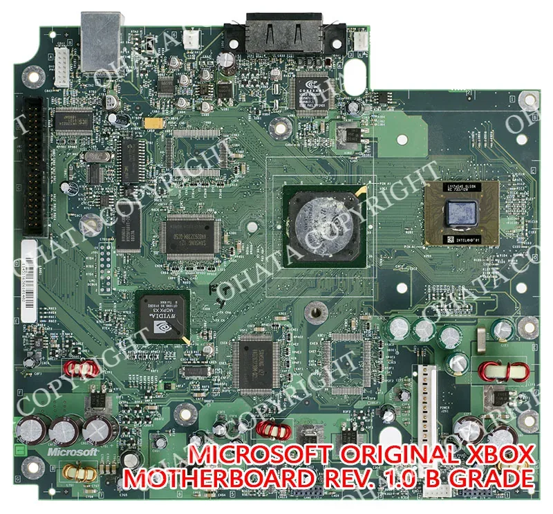 Microsoft original Xbox revision 1.0 motherboard with its main processor packages, memory devices, controller ICs, connectors, capacitors, and power circuitry.