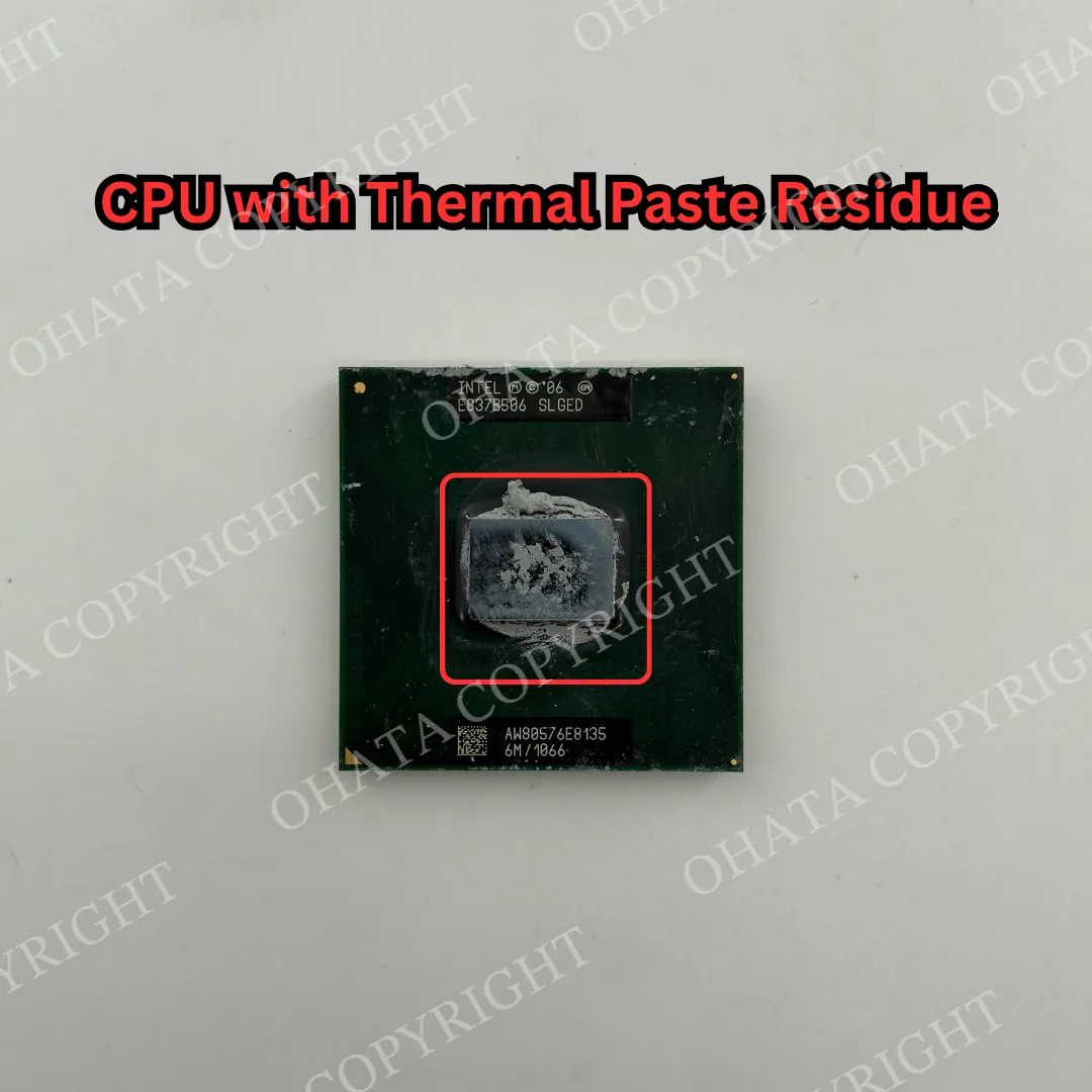 Intel CPU with gray thermal paste residue visible on the top heat spreader.