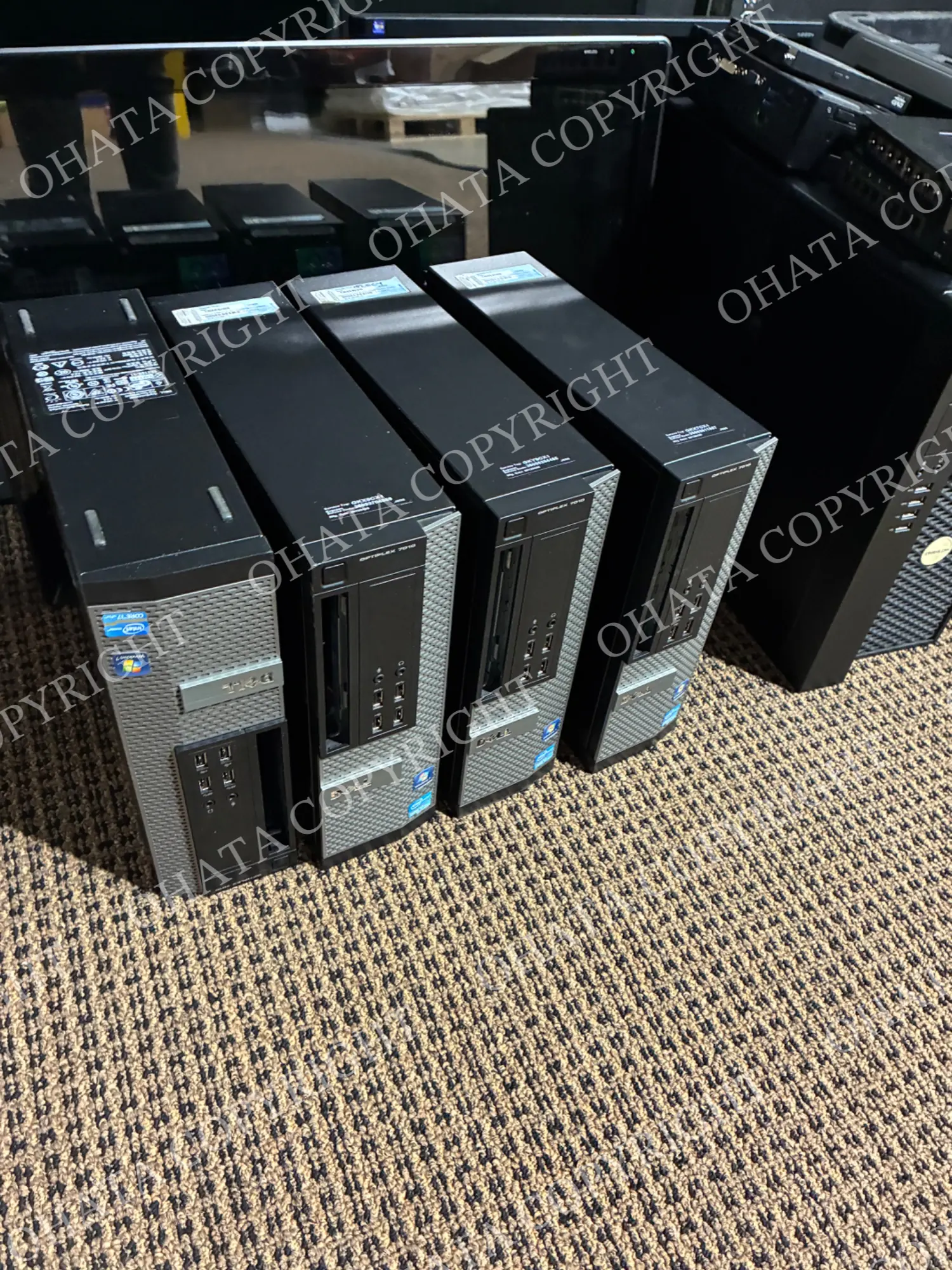 Dell OptiPlex desktop computers lined up on the floor at Ohata’s Richmond yard.