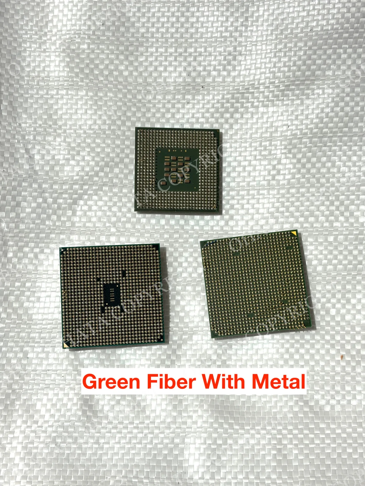 Pin-side views of three green CPU packages arranged on a white background.