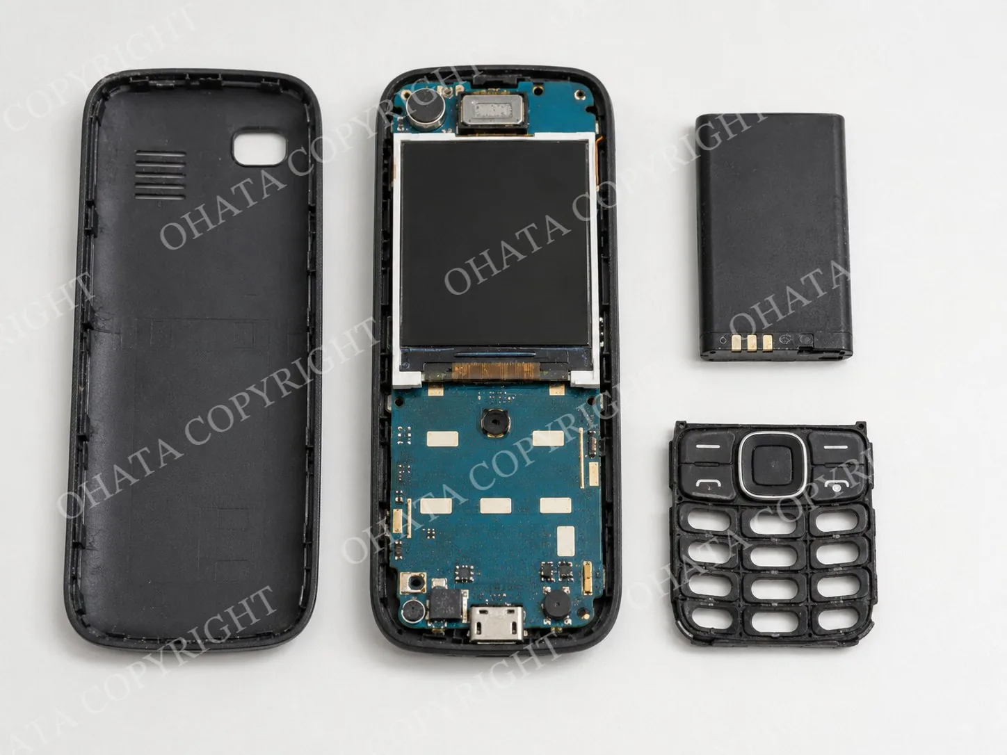 Partially dismantled non-smart phone without its battery, back cover, or keypad