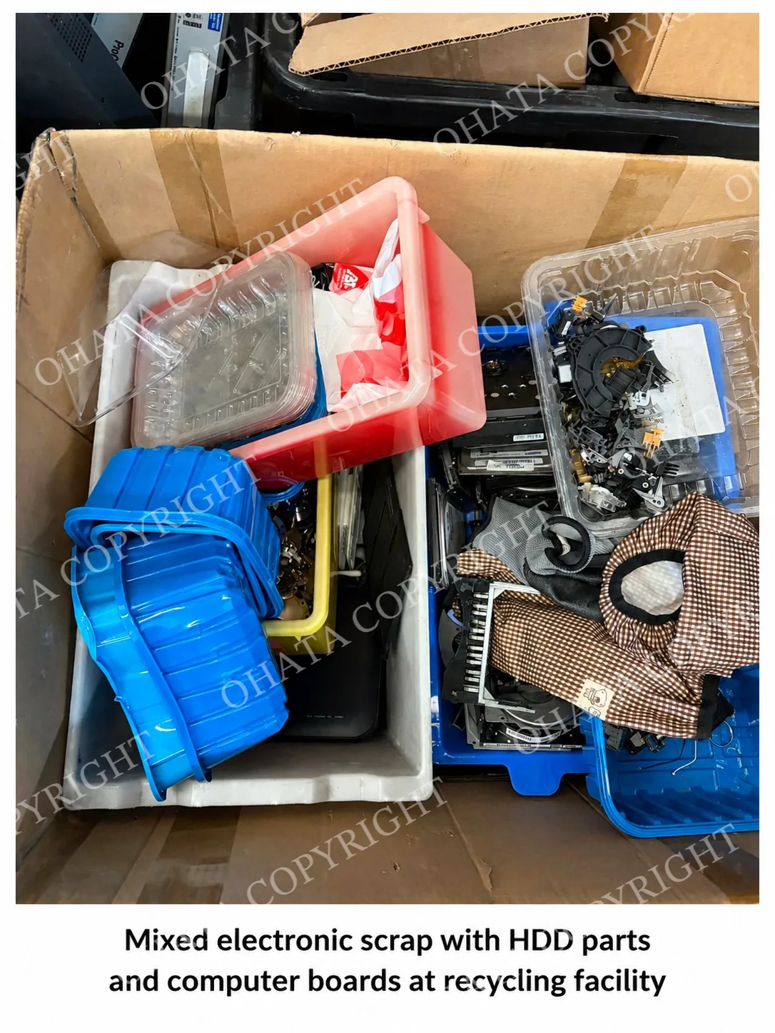Mixed electronic scrap with HDD parts and computer boards at recycling facility