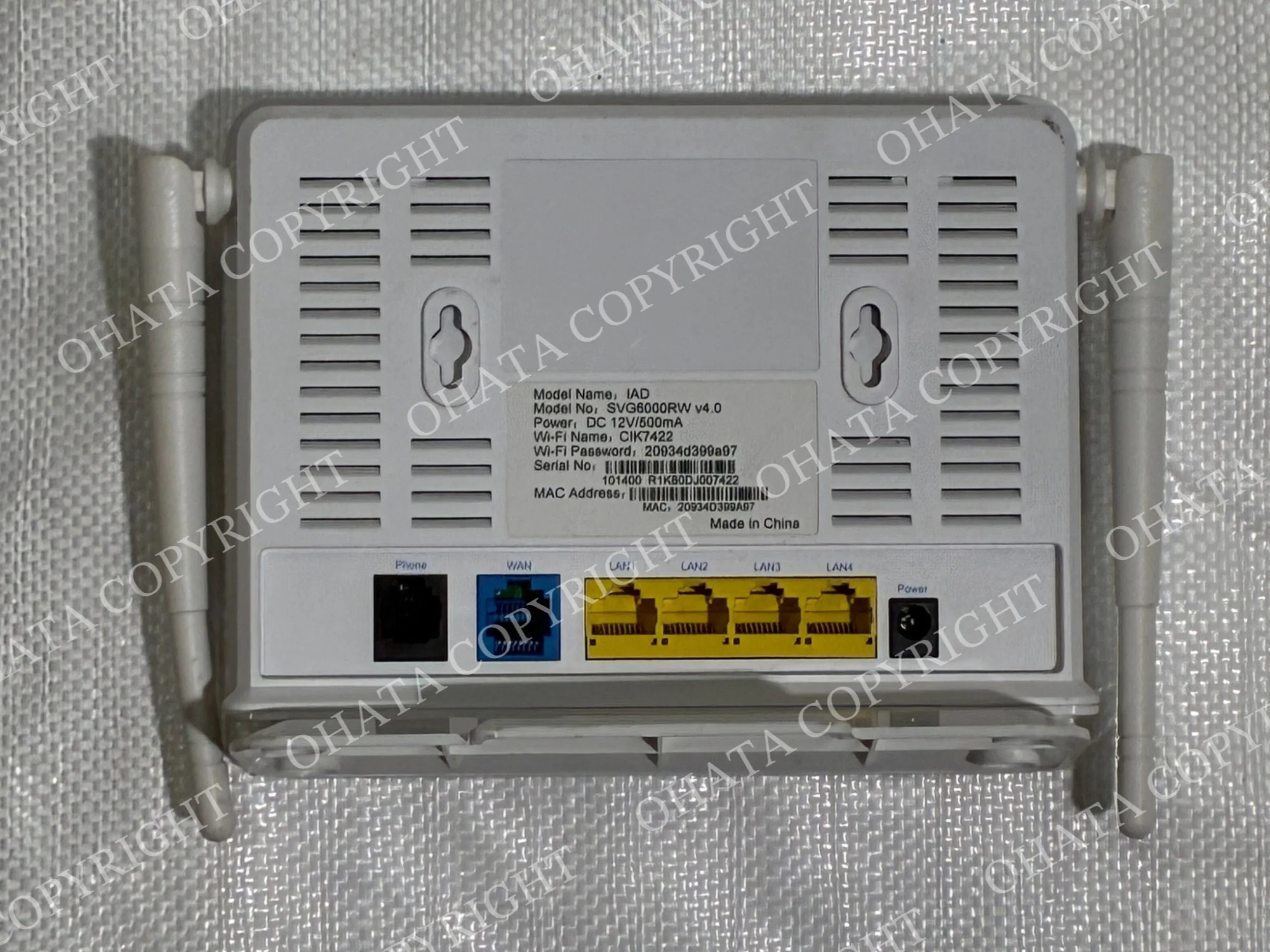 Rear of a CIK Telecom router showing phone, WAN, four LAN Ethernet ports, power input, ventilation openings, and product label.
